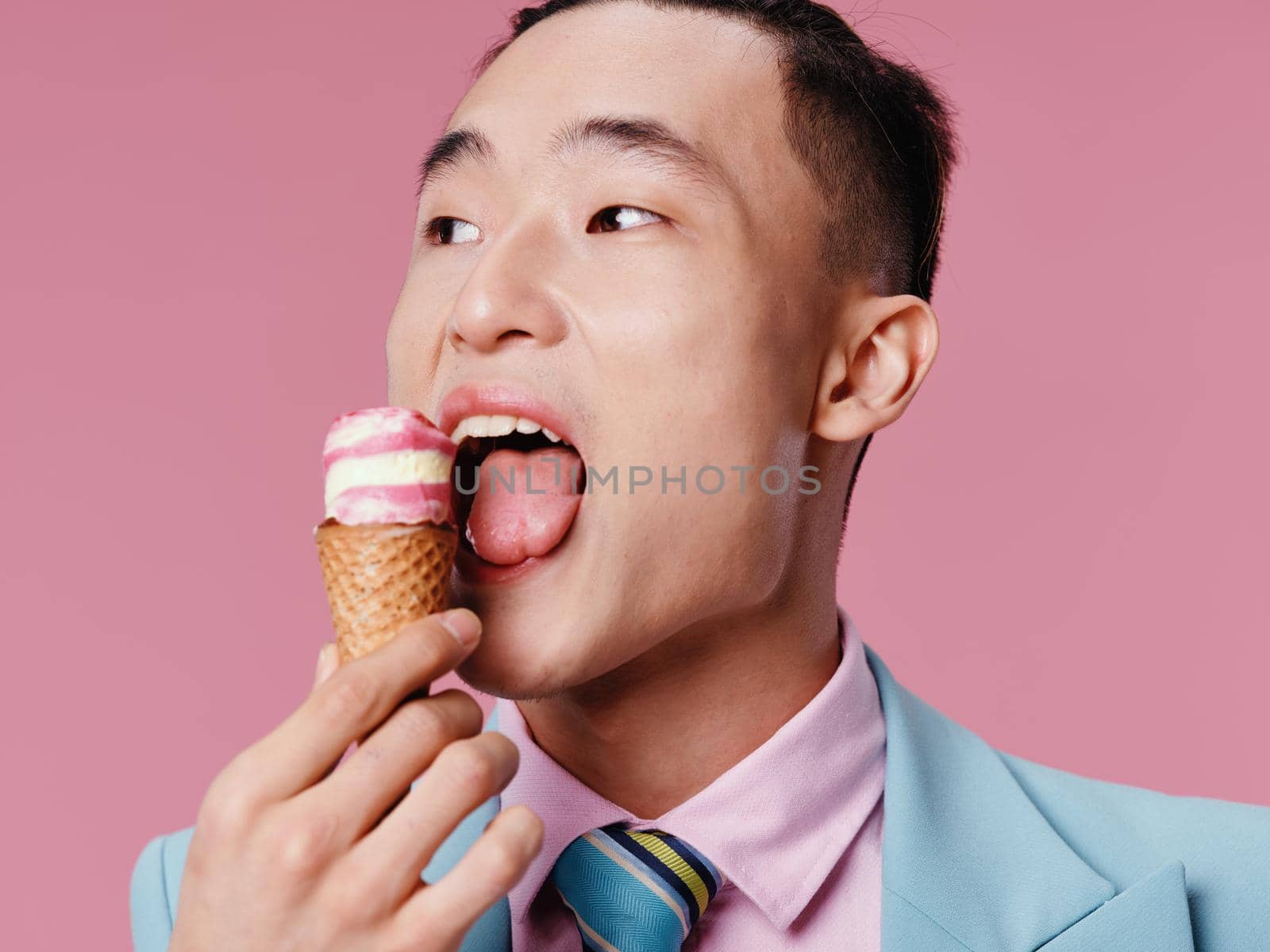 A man in a suit examines ice cream in a cone and professional by SHOTPRIME