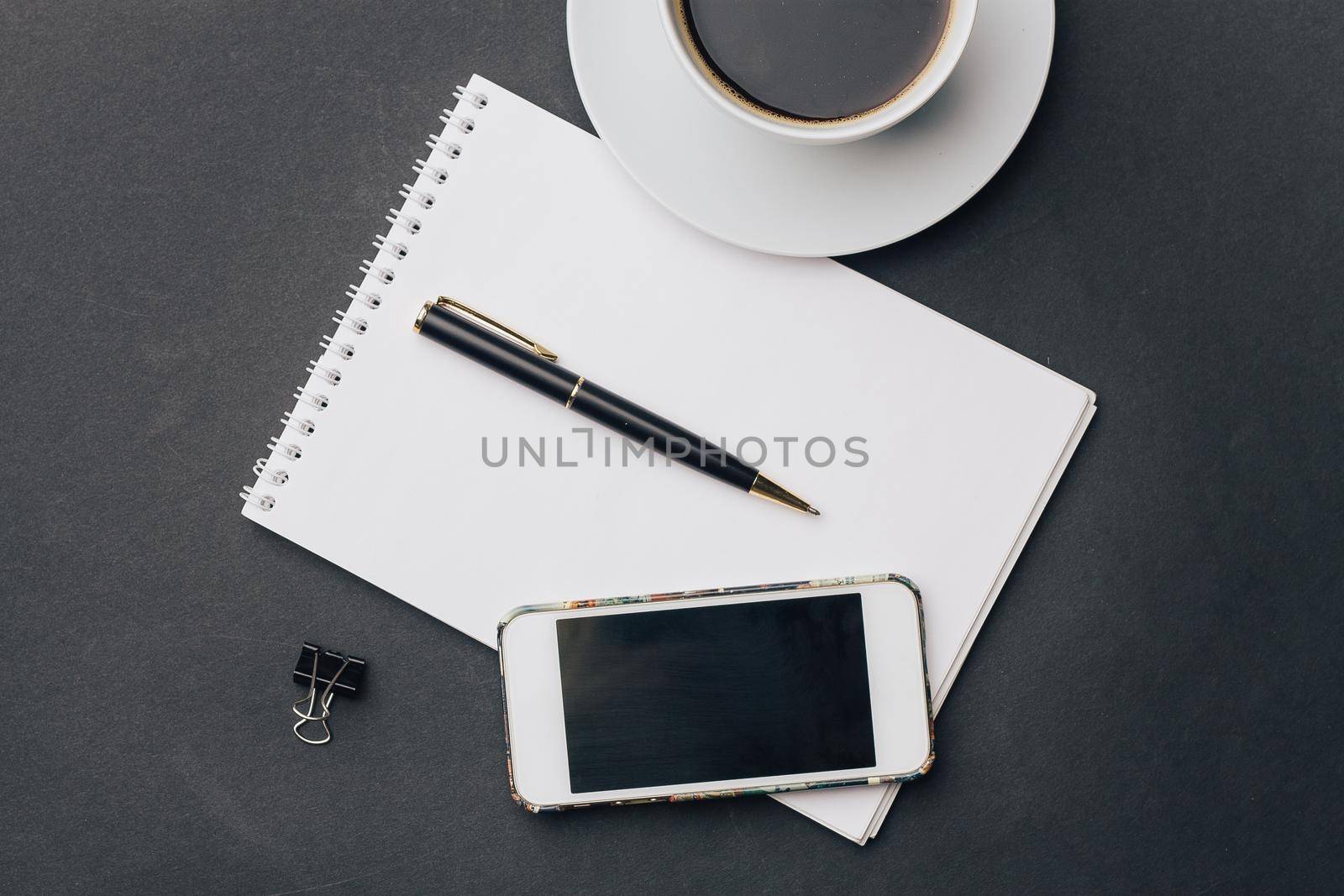 work desk notepad with pen drink cup phone technology. High quality photo