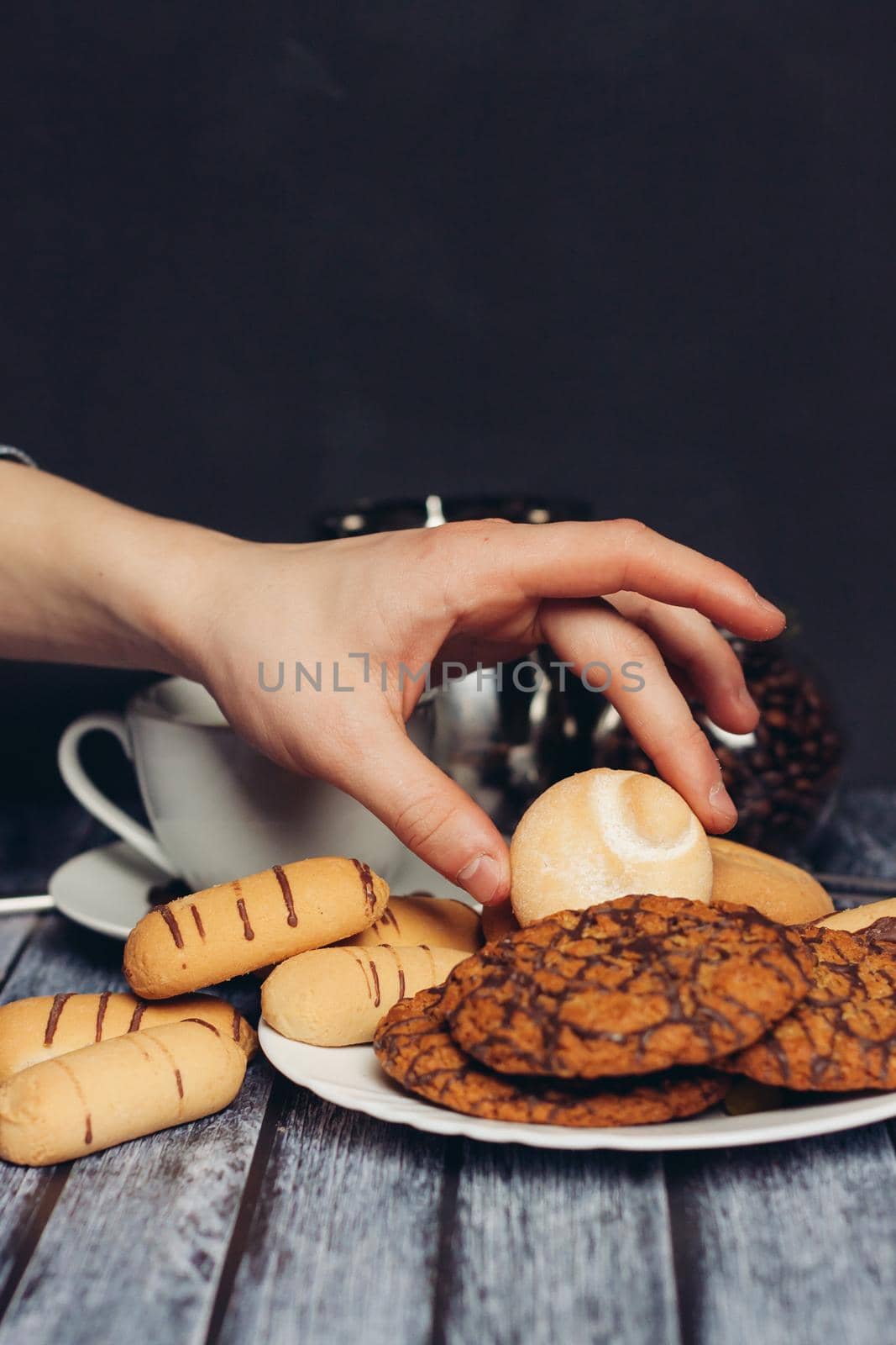 cookies on a plate a cup of tea on a wooden table by SHOTPRIME