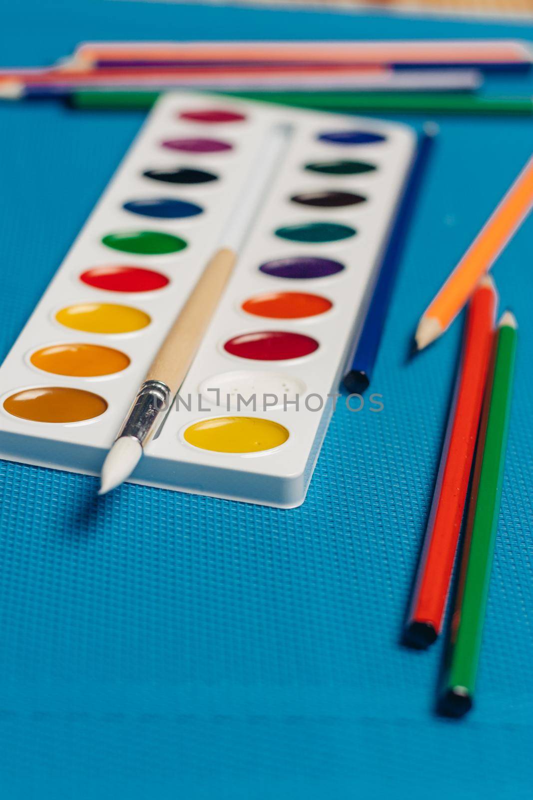 bright watercolor paint colored pencils stationery. High quality photo