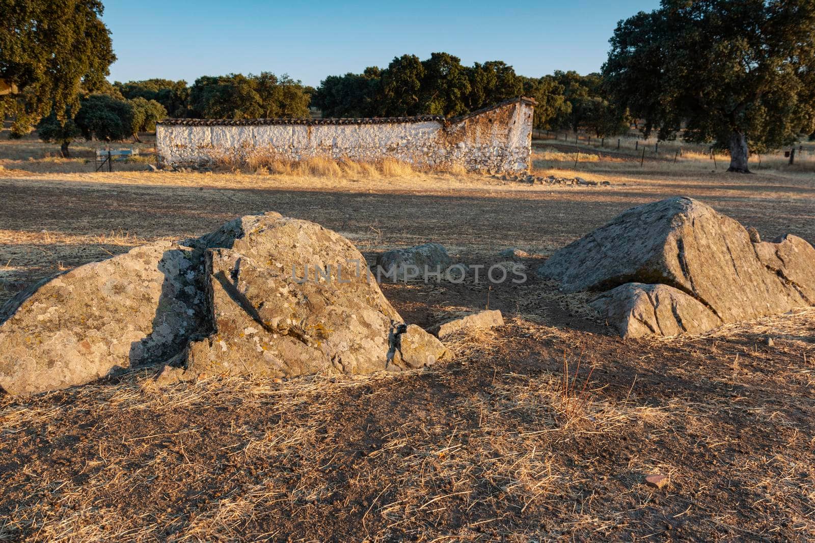 large stones on a farm at sunset by loopneo