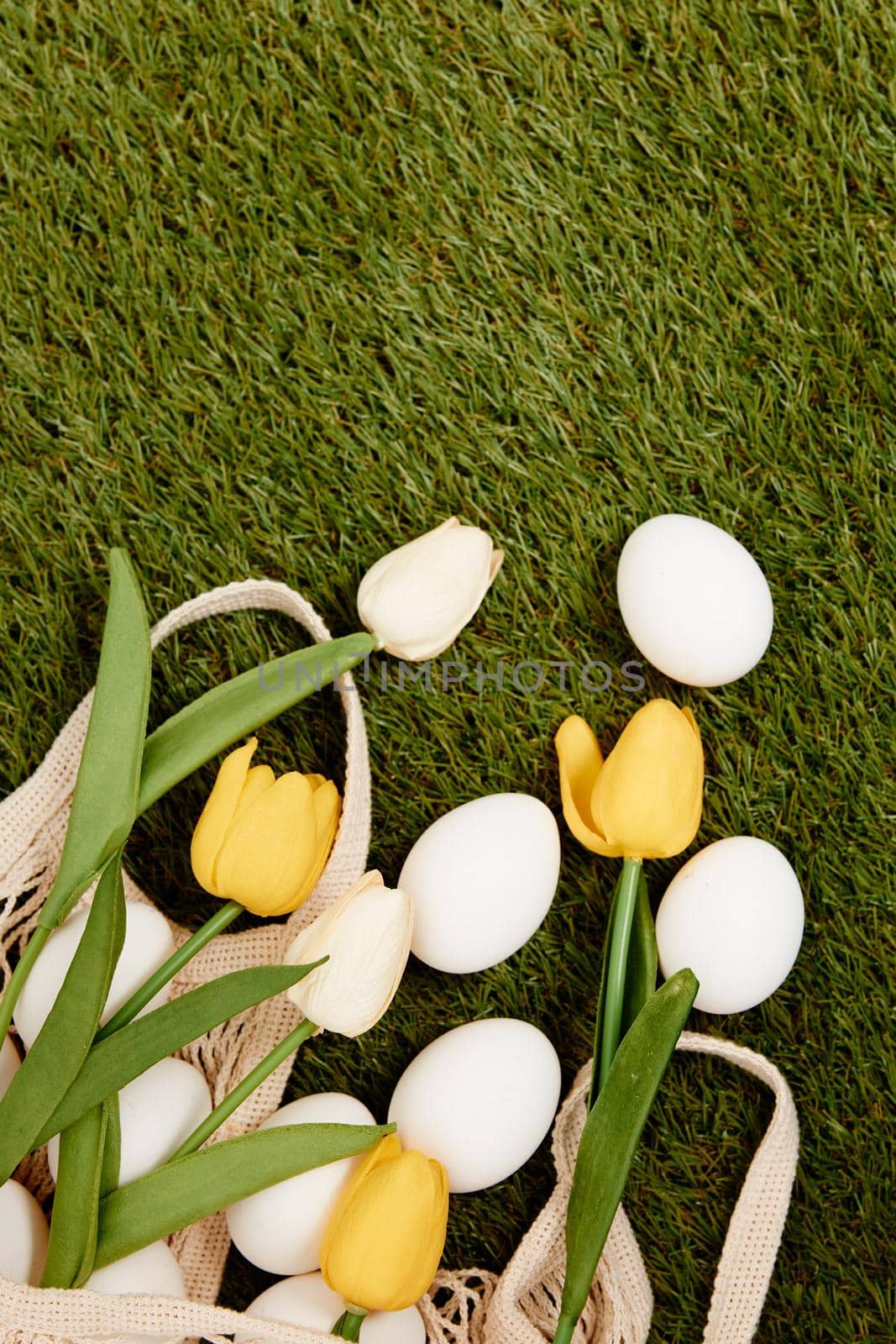 Yellow tulips white eggs spring holiday easter tradition. High quality photo