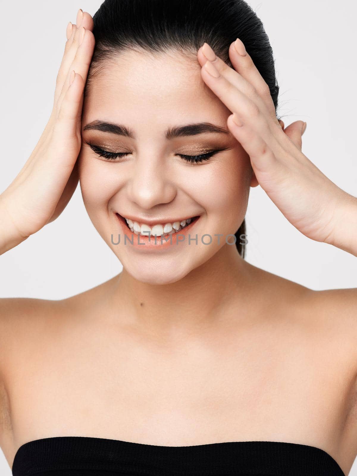 brunette with bare shoulders closed eyes cosmetics glamor. High quality photo