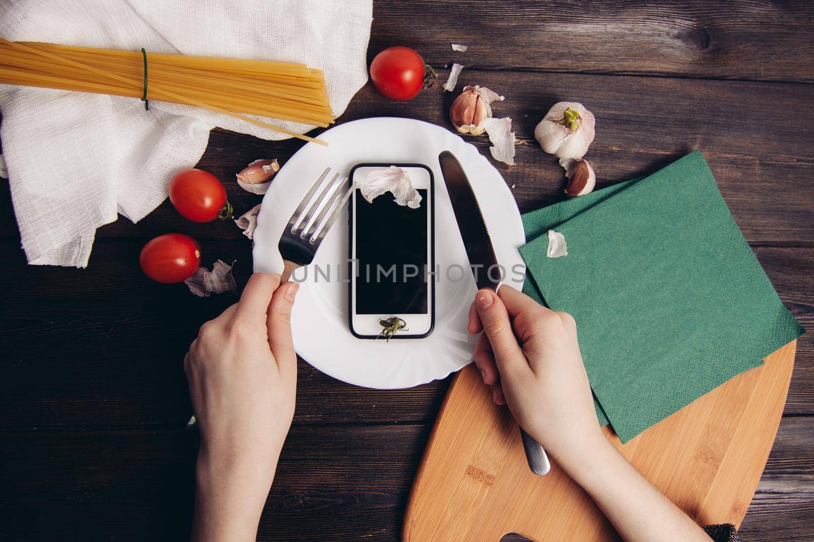 phone in a plate slicing with a knife eating wooden table by SHOTPRIME