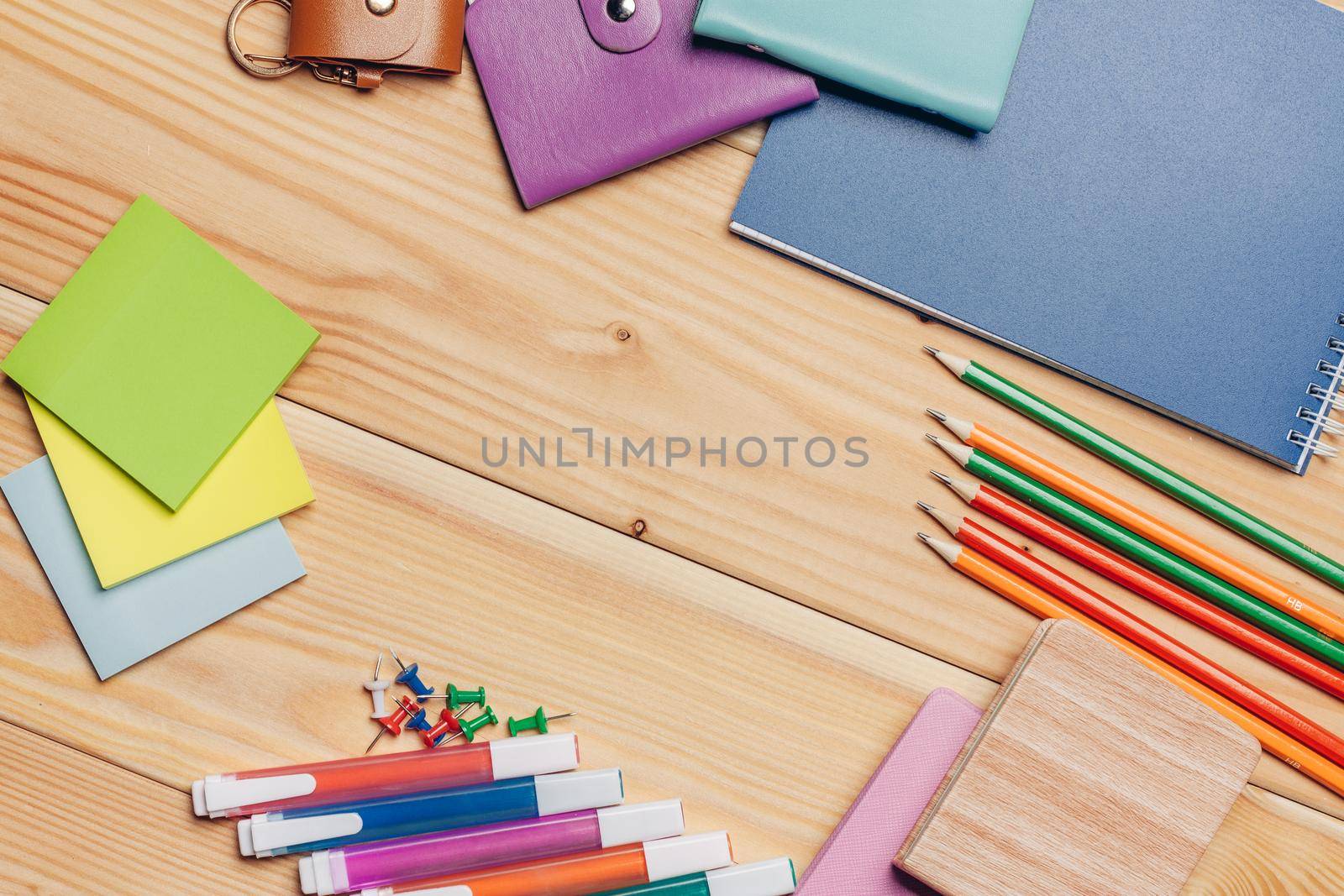 multicolored business card holders pencils notepads school objects top view by SHOTPRIME