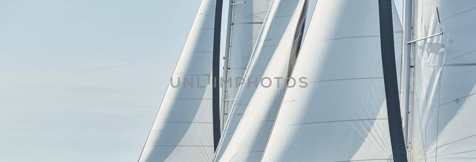 Spinnaker and sail of white color, Sailboats compete in a sailing regatta at sunset, sailing race