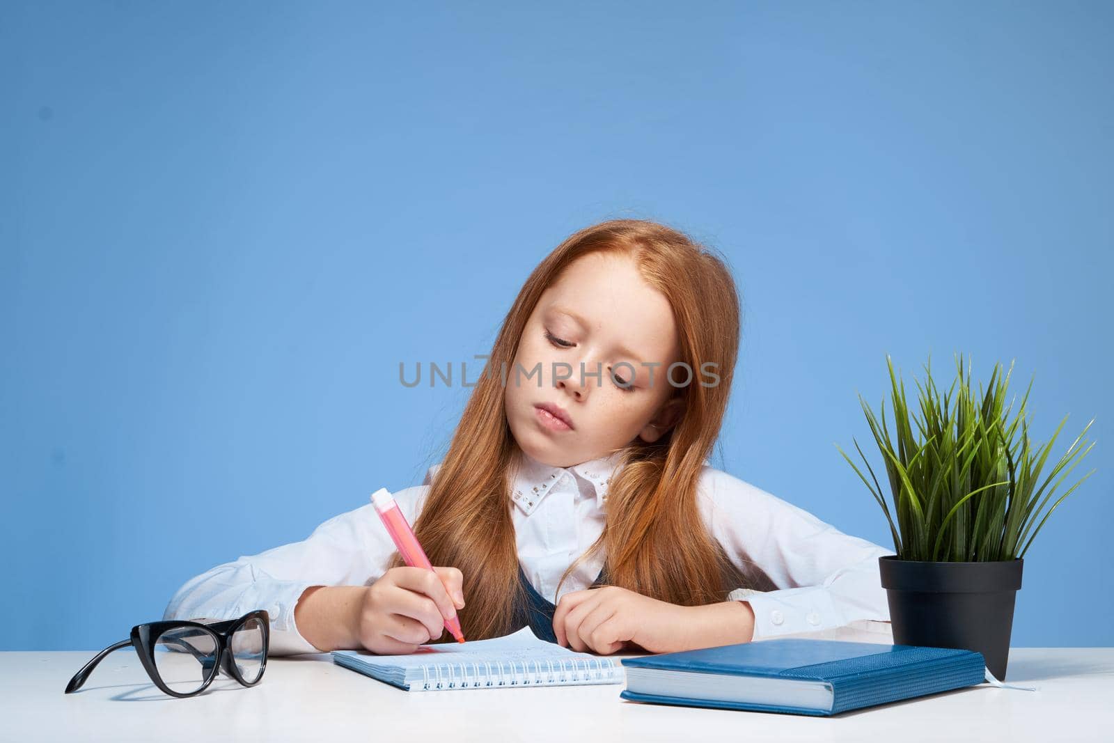 schoolgirl doing homework at the table education lifestyle. High quality photo