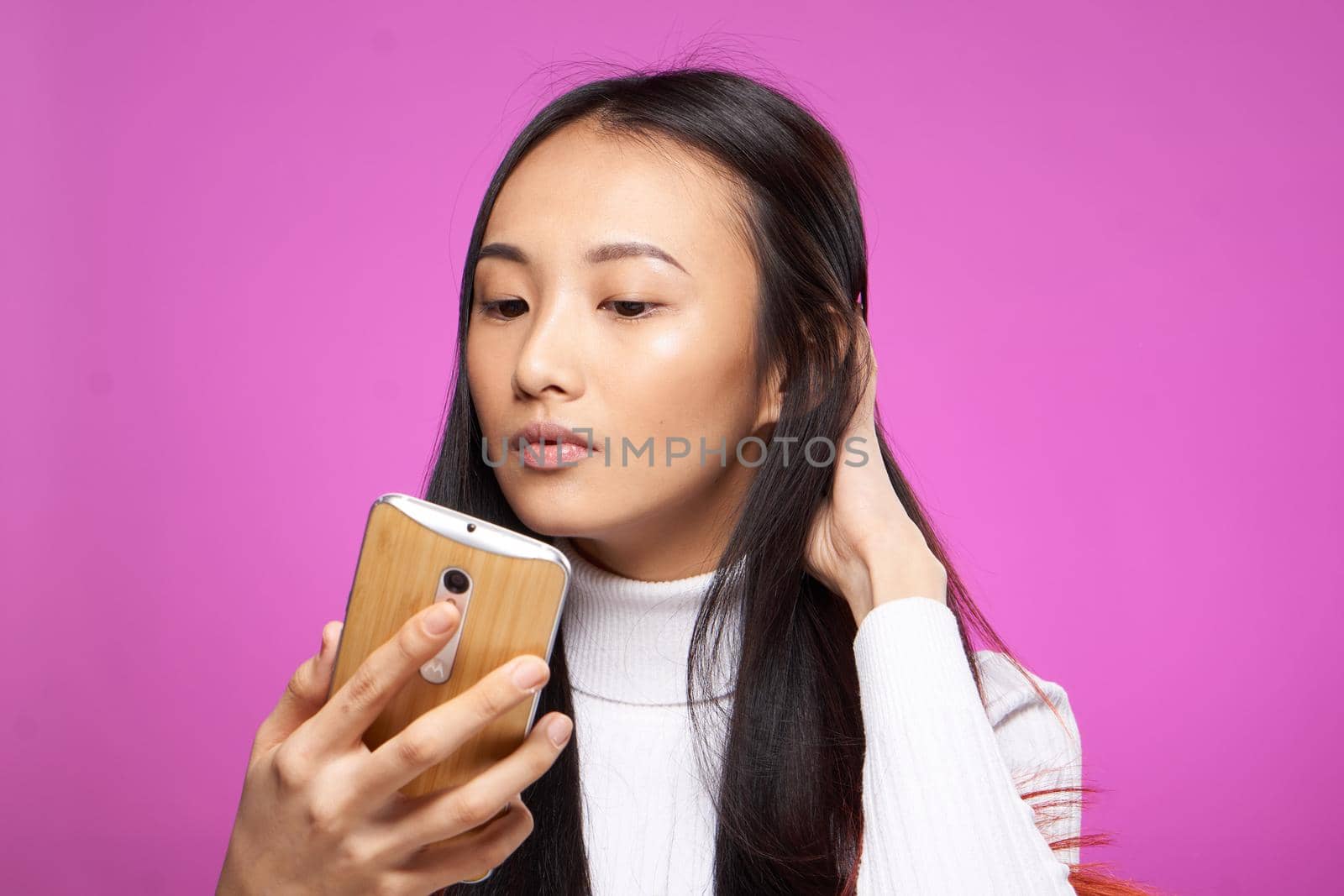 pretty woman with a phone in her hands looking at the screen internet communication technology. High quality photo