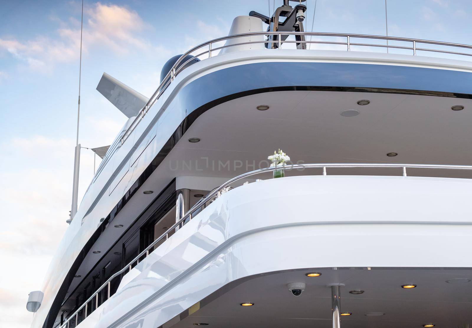 The top deck of a huge yacht at sunset, Glossy board of the boat, The chromeplated handrail