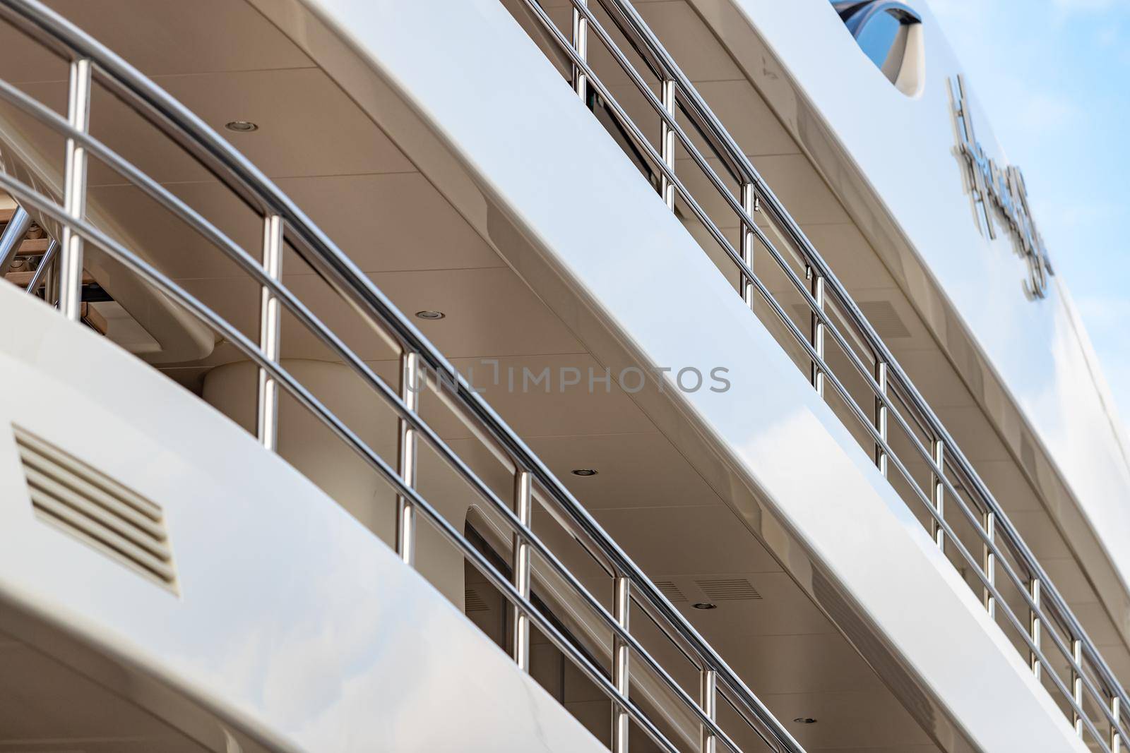 Monaco, Monte-Carlo, 27 September 2019: The top deck of a huge yacht at sunset, glossy board of the boat, the chromeplated handrail