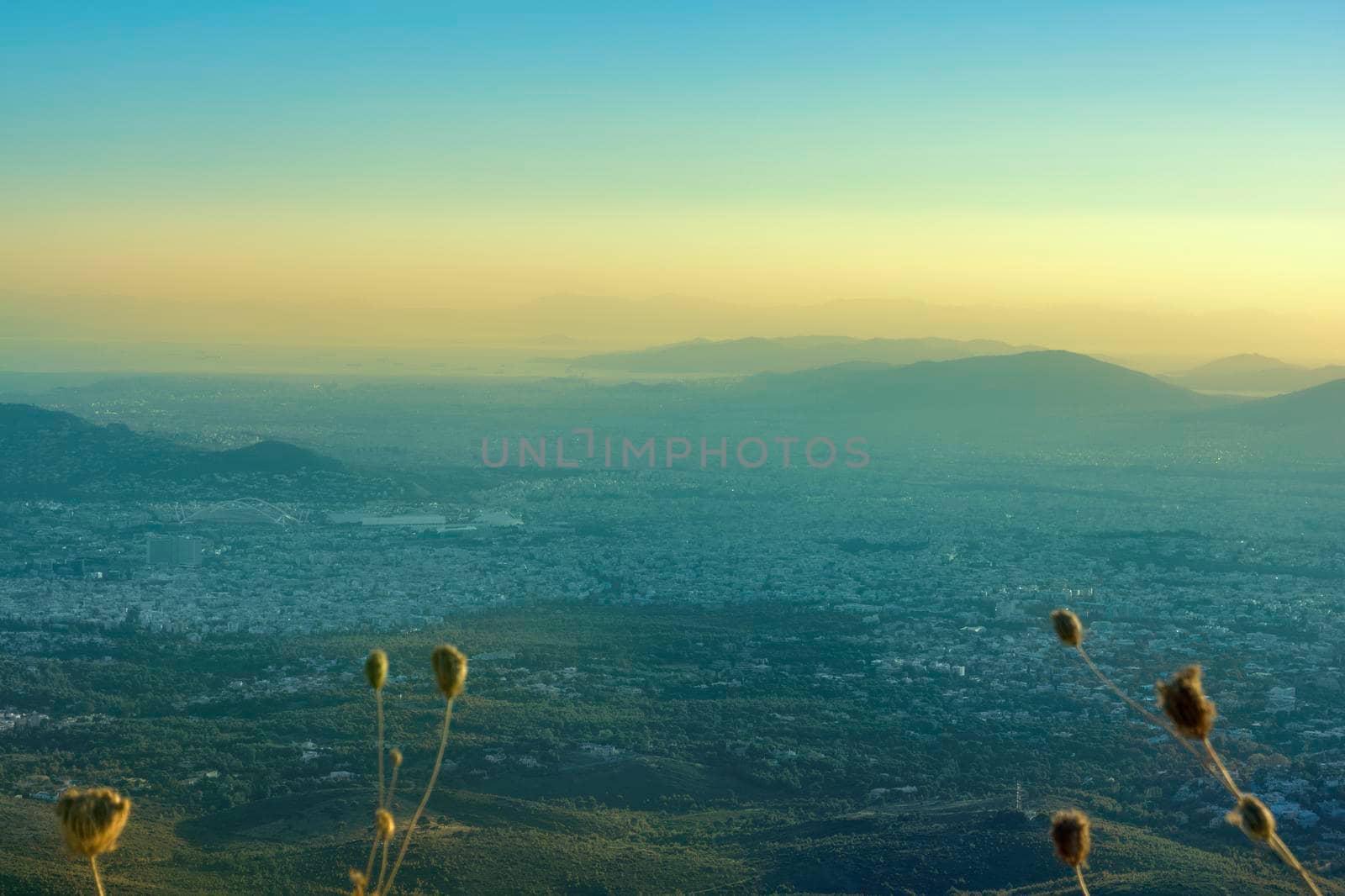 Panoramic view over Athens, taken shot from Penteli mountain at sunset.