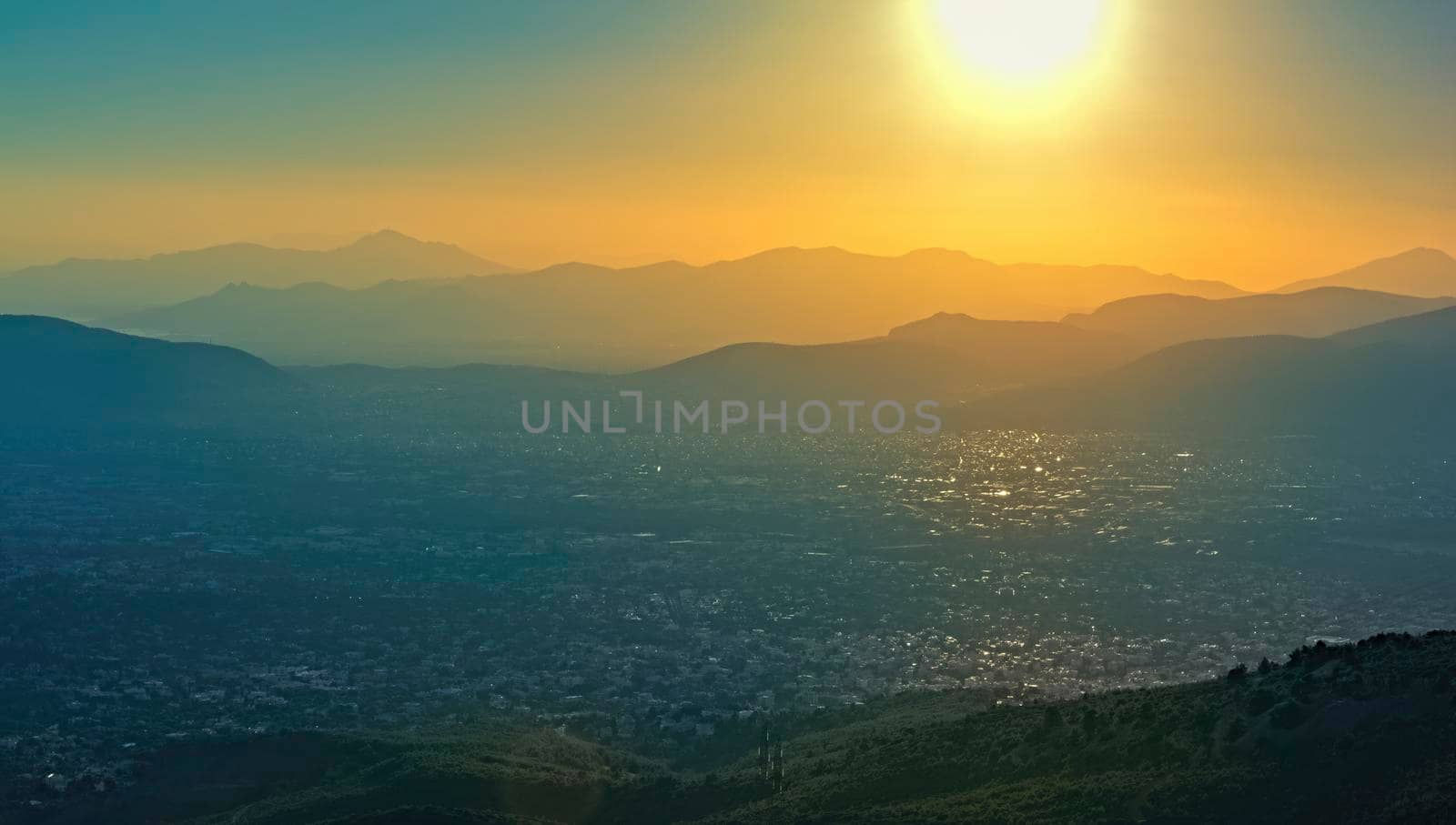Panoramic view over Athens, taken shot from Penteli mountain at sunset.