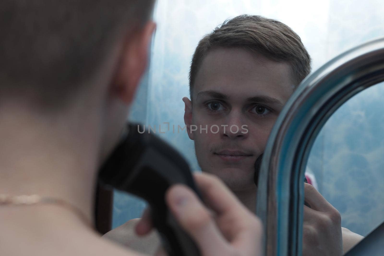 A young man of European appearance bleats his face with a safe bow. by Olga26