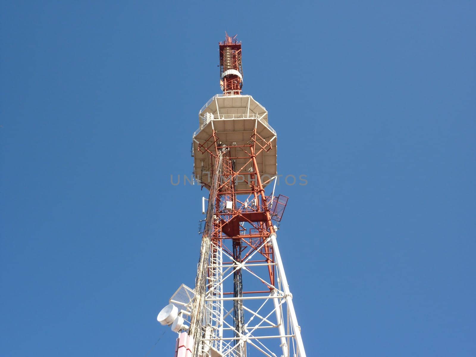 High TV tower against the blue sky. by Olga26