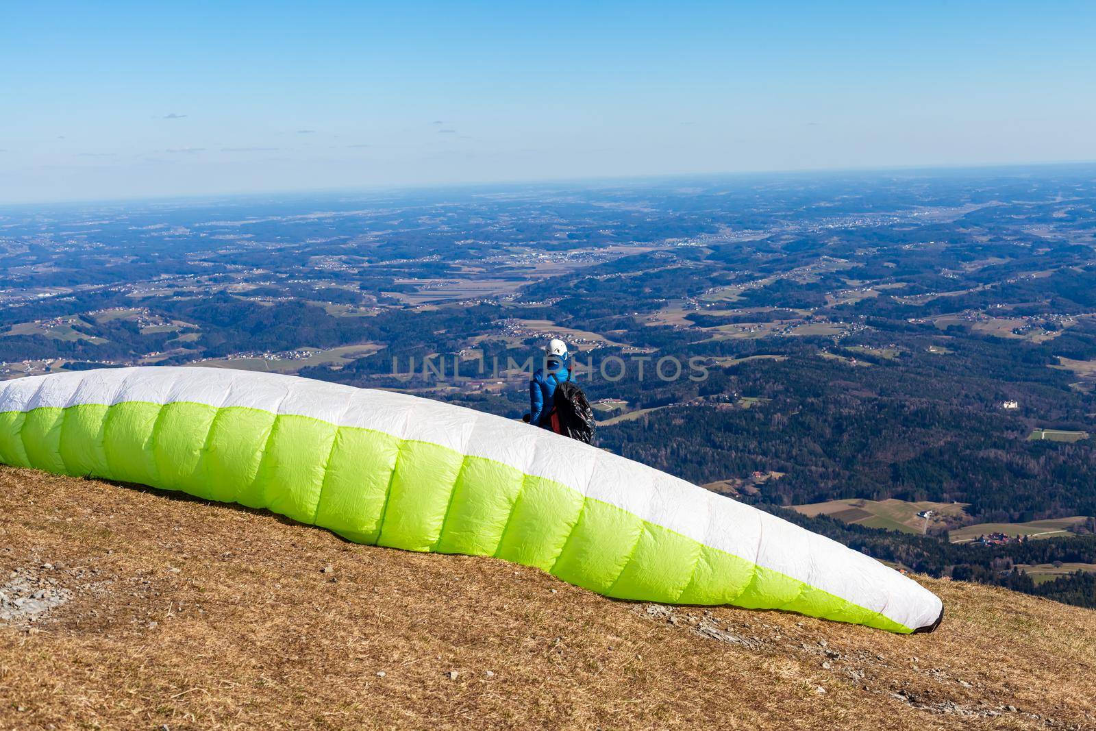 sports paragliding on a parachute over the countryside.