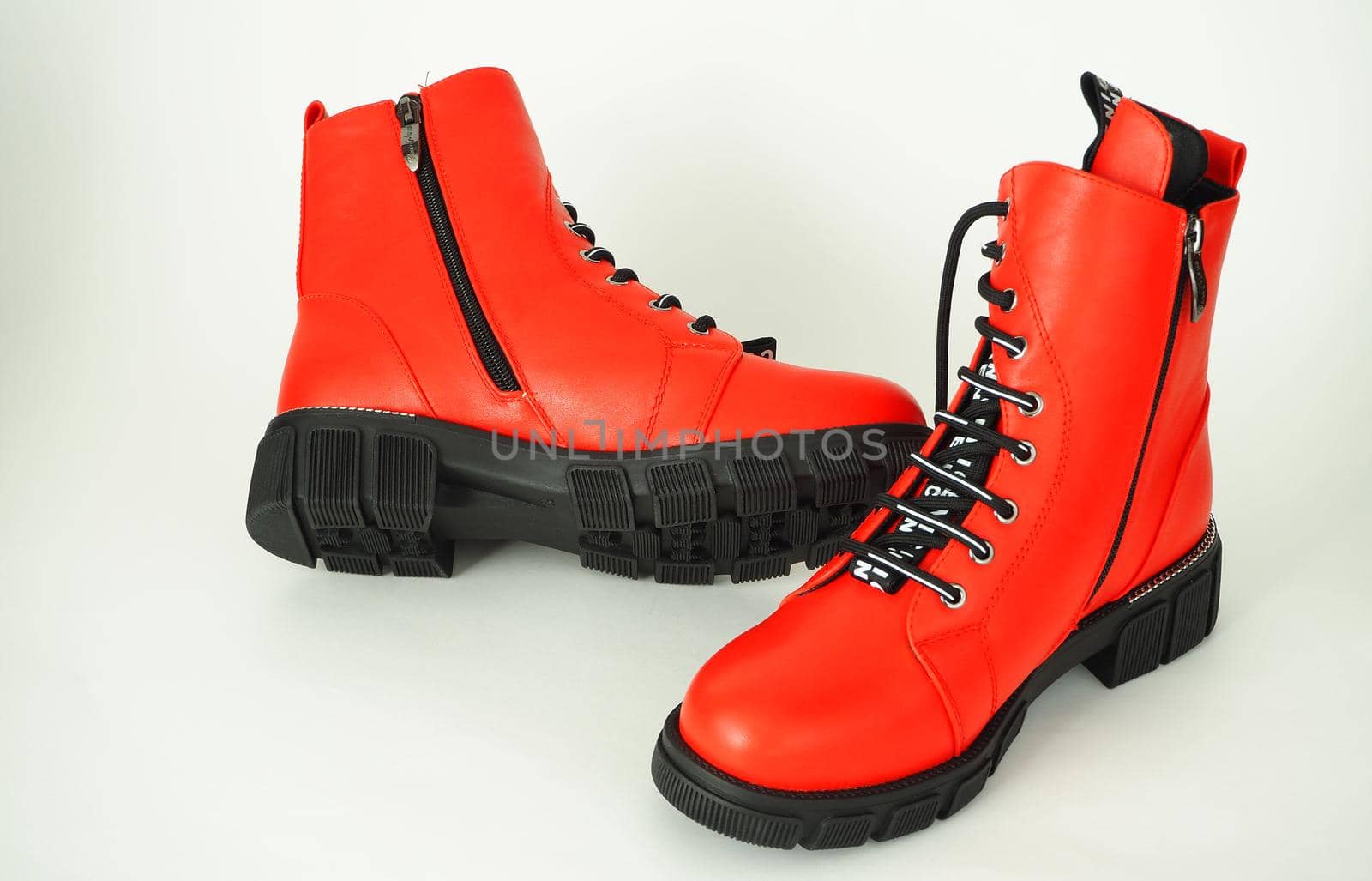 Fashionable womens shoes are red, with zipper and lacing, insulated on a white background. High quality photo