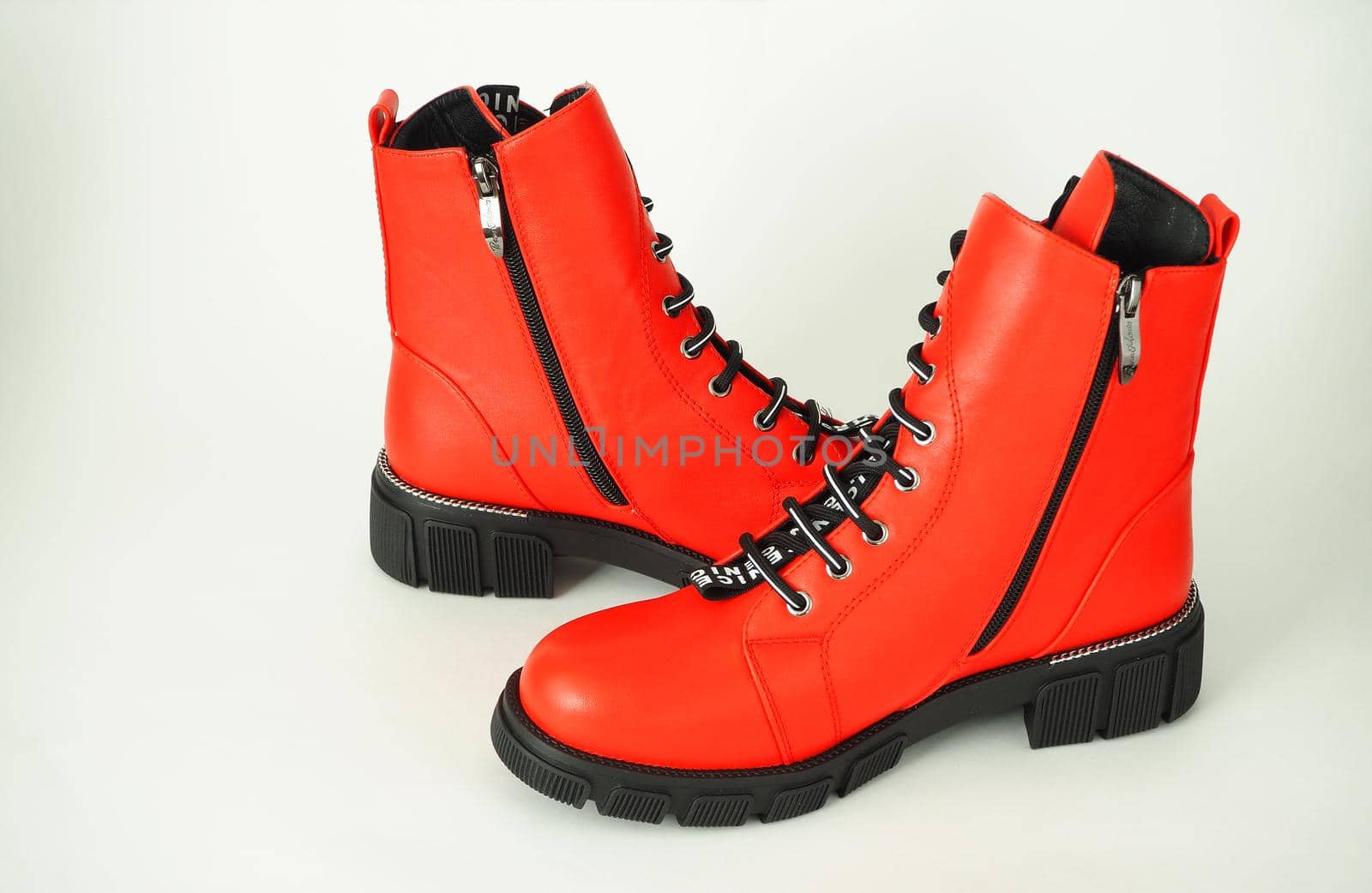 Fashionable womens shoes are red, with zipper and lacing, insulated on a white background. High quality photo