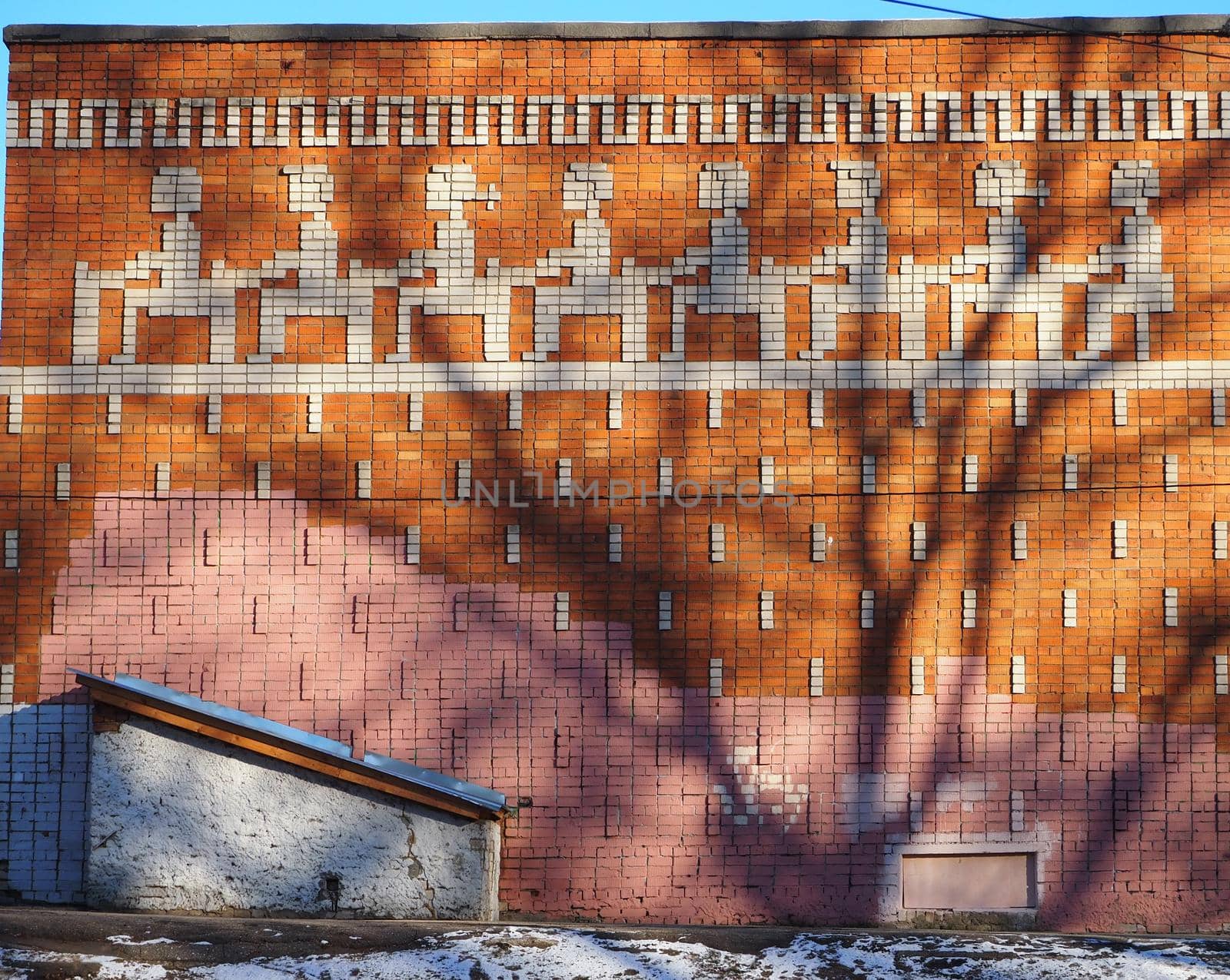The brick wall of the school building with mosaics. High quality photo