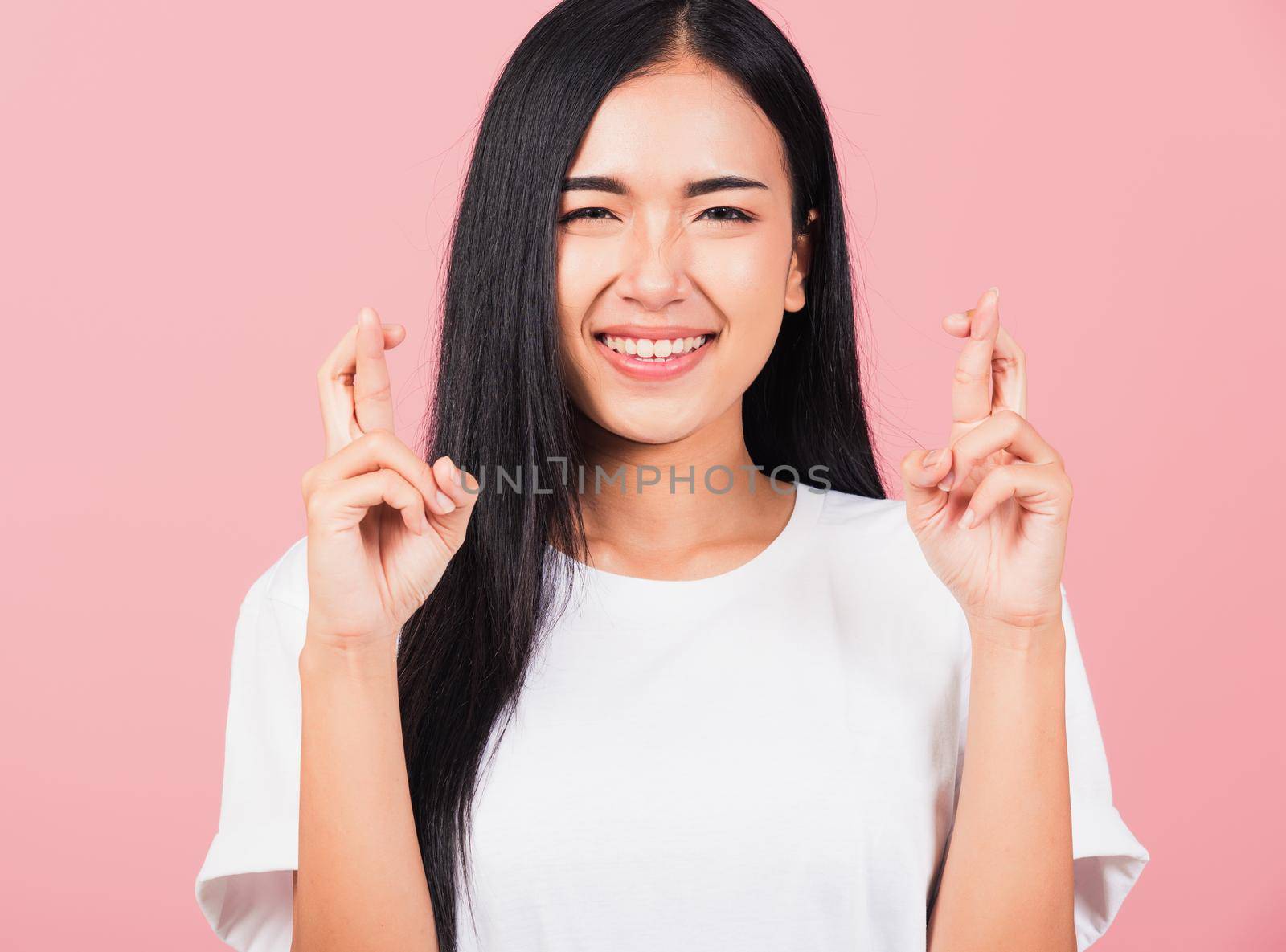 woman smile have superstition her holding fingers crossed by Sorapop