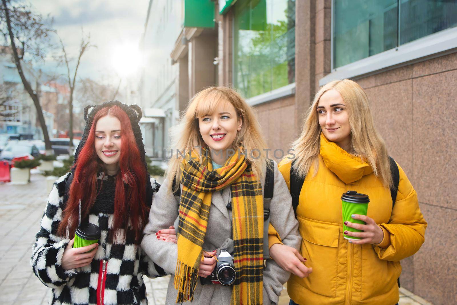 holidays, food and tourism concept - three beautiful girls walking around the city drinking coffee and and taking pictures by Nickstock