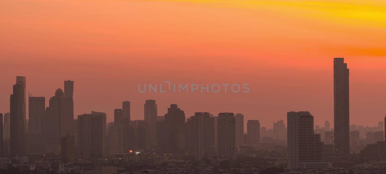 Air pollution. Smog and fine dust of pm2.5 covered city in the morning with orange sunrise sky. Cityscape with polluted air. Dirty environment. Urban toxic dust. Unhealthy air. Urban unhealthy living. by Fahroni