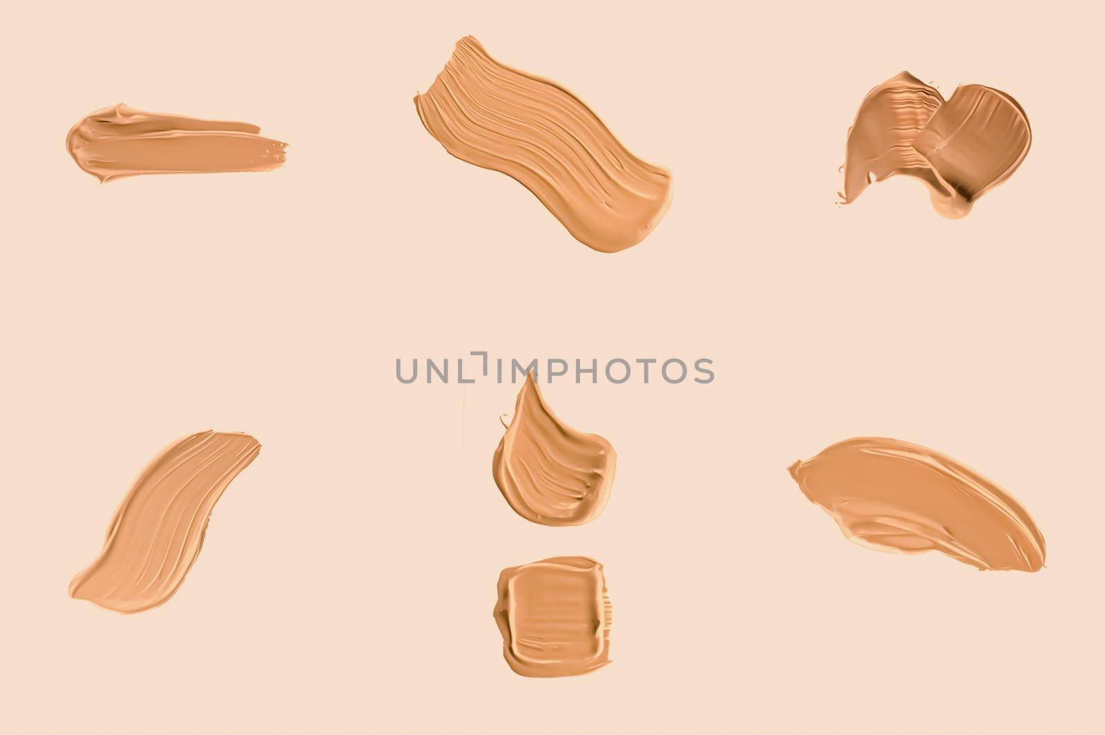 Liquid foundation smudges, smears and strokes as makeup textures isolated on beige background, beauty and cosmetics by Anneleven