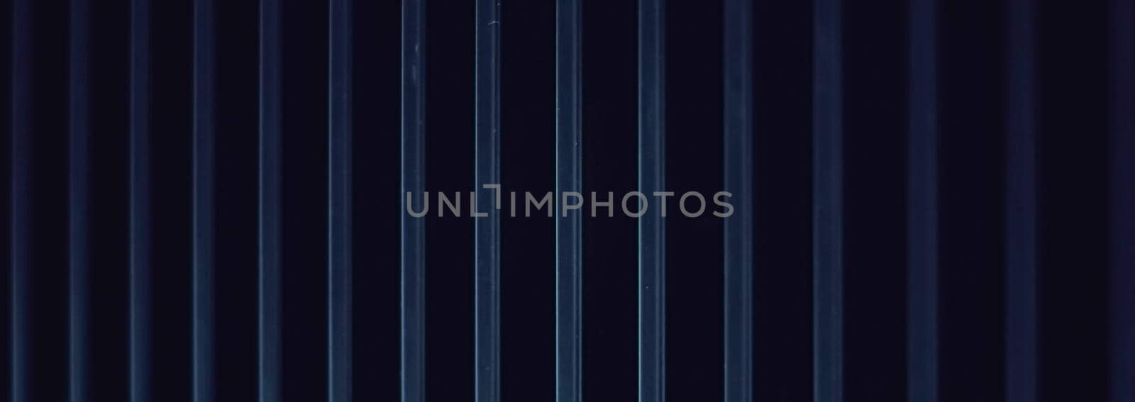 Dark blue metal background as industrial and futuristic urban backdrop by Anneleven