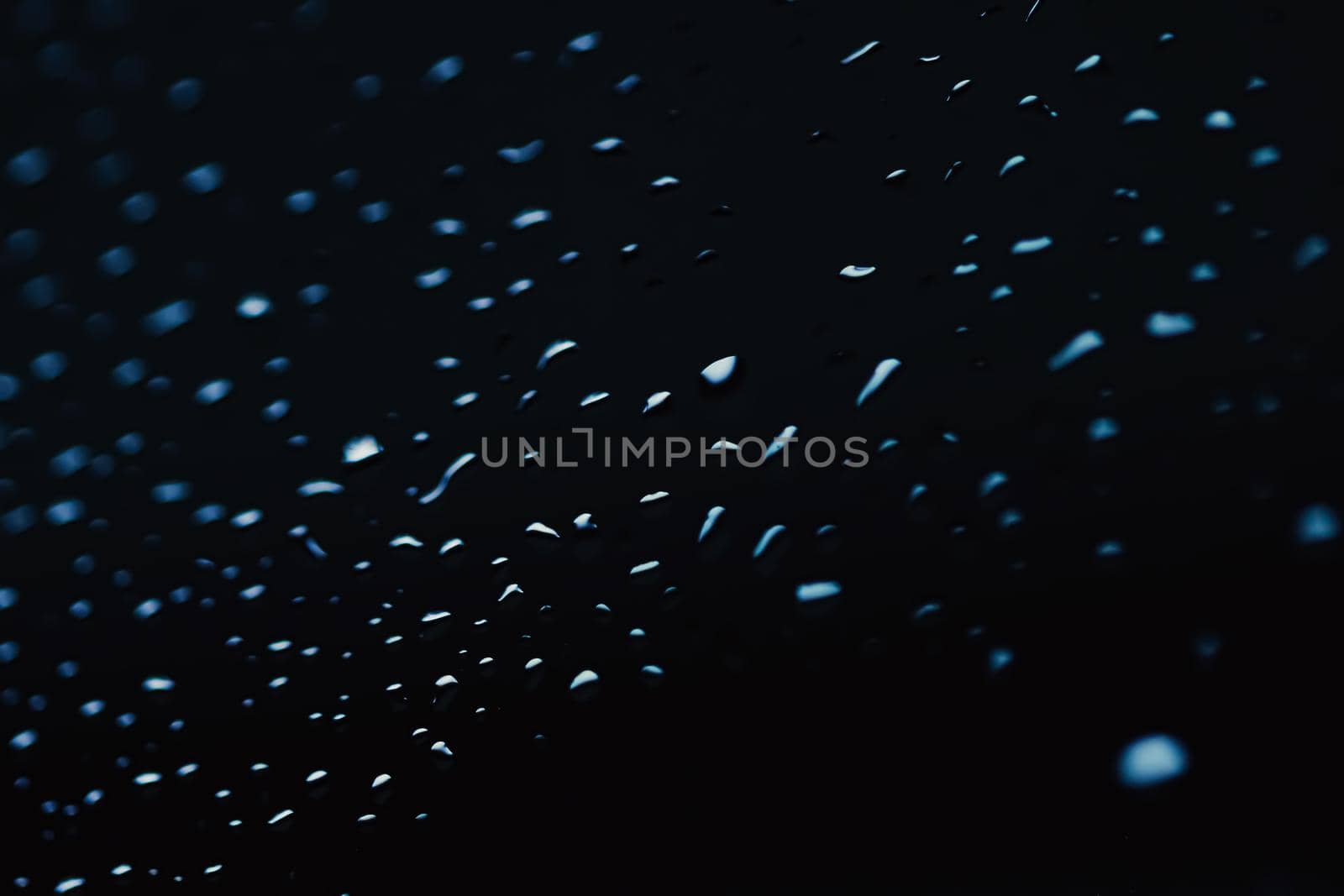 Liquid water drops on glass surface, abstract backdrop and science background concept