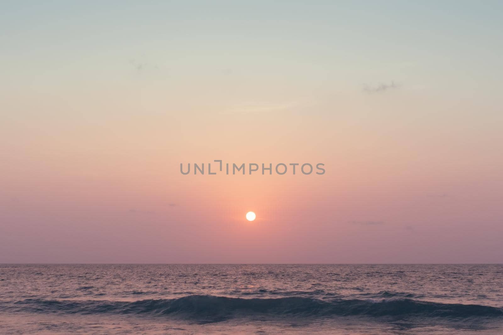 Colorful vibrant ocean sea wave beach summer with sunrise or sunset background landscape on vacation day. 