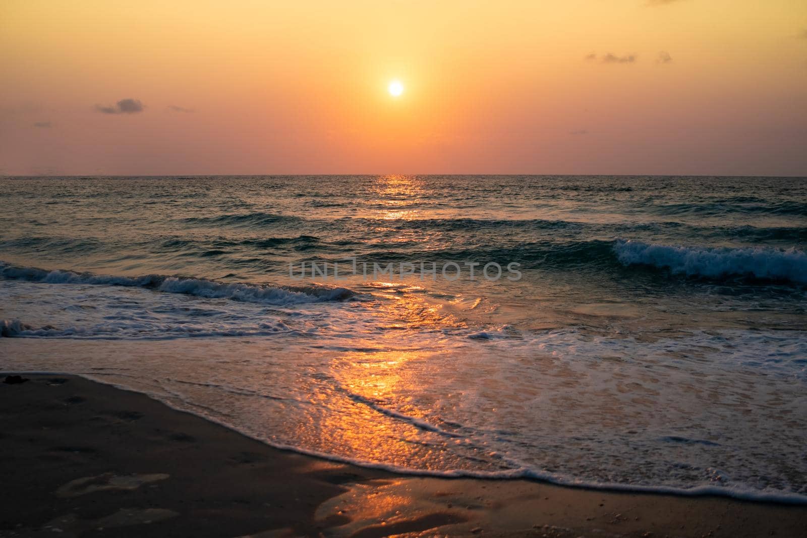 Colorful vibrant ocean sea wave beach summer with sunrise or sunset background landscape on vacation day. 