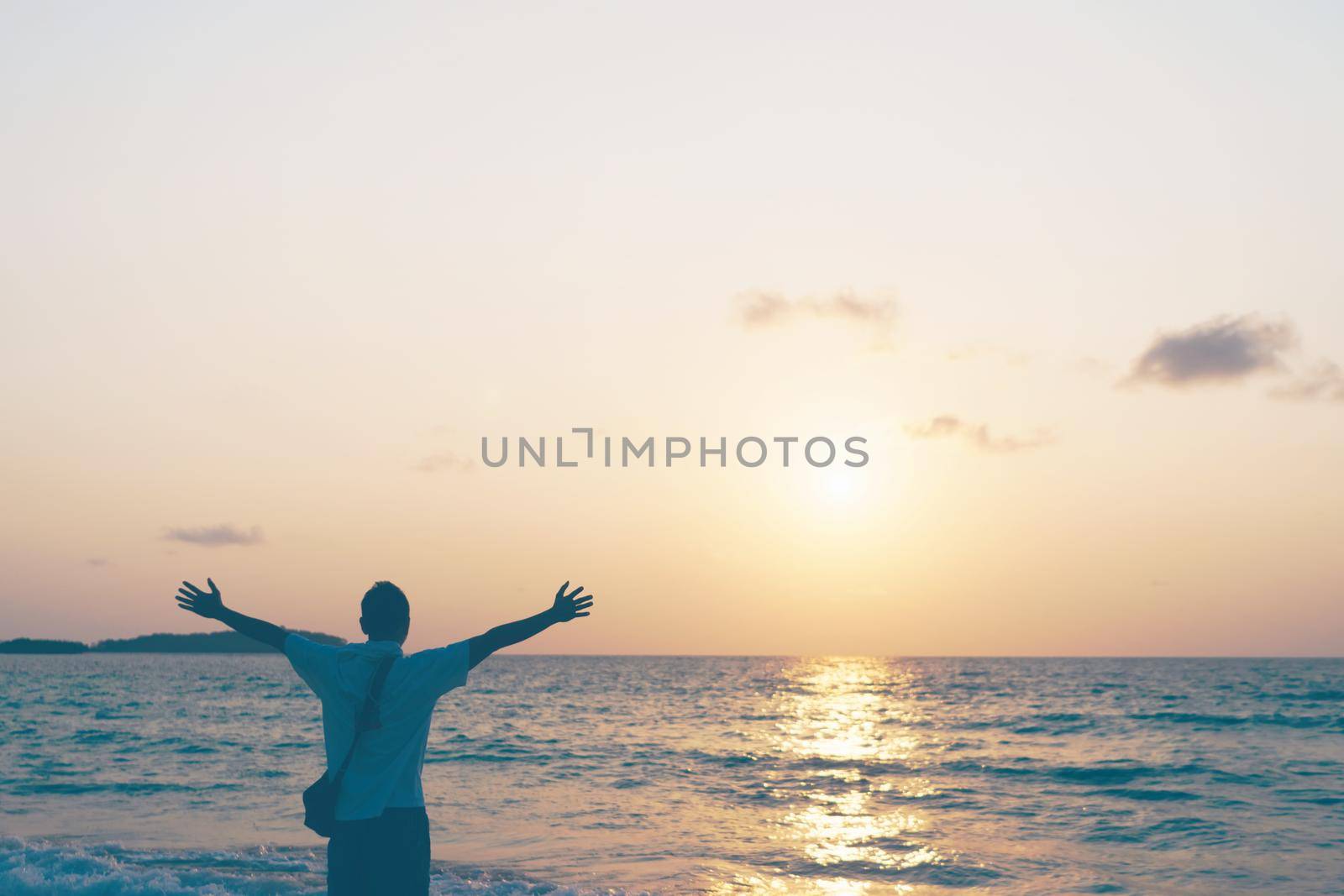 Man rise hands up to sky travel around the world with summer beach freedom and relax life.