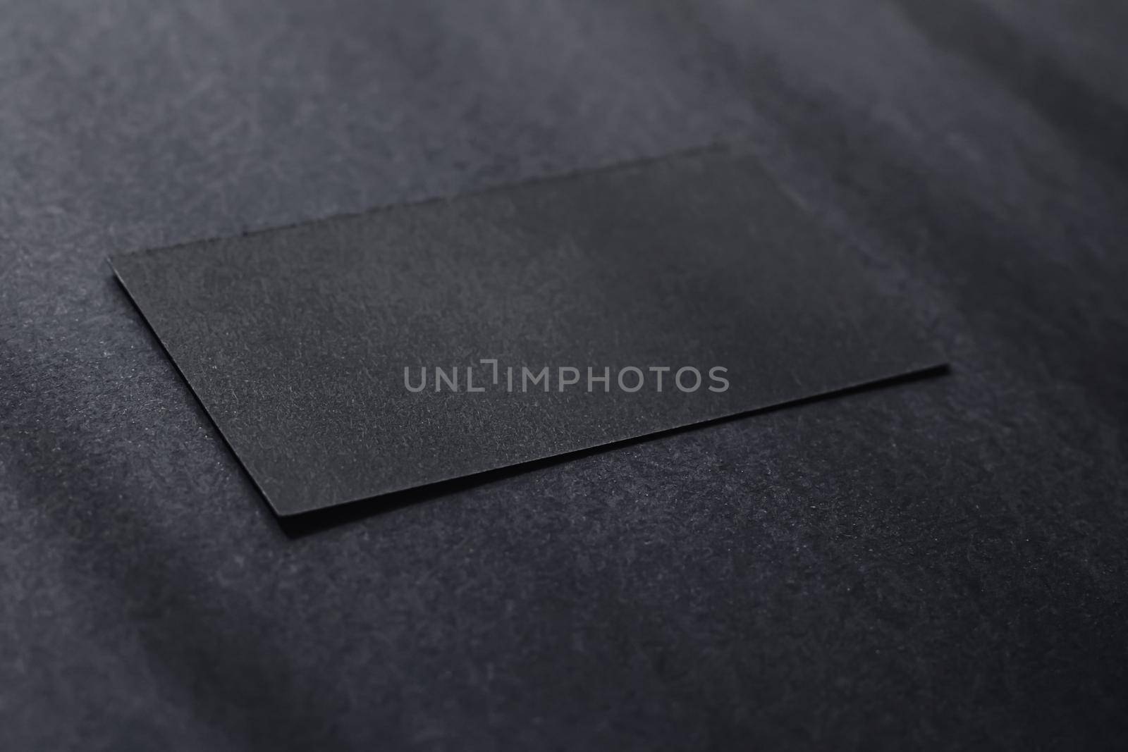 Black business card on dark flatlay background and sunlight shadows, luxury branding flat lay and brand identity design for mockups