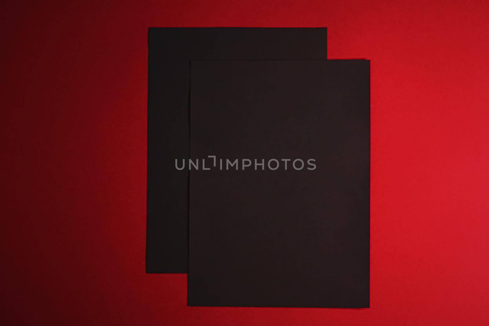 Black A4 papers on red background as office stationery flatlay, luxury branding flat lay and brand identity design for mockups