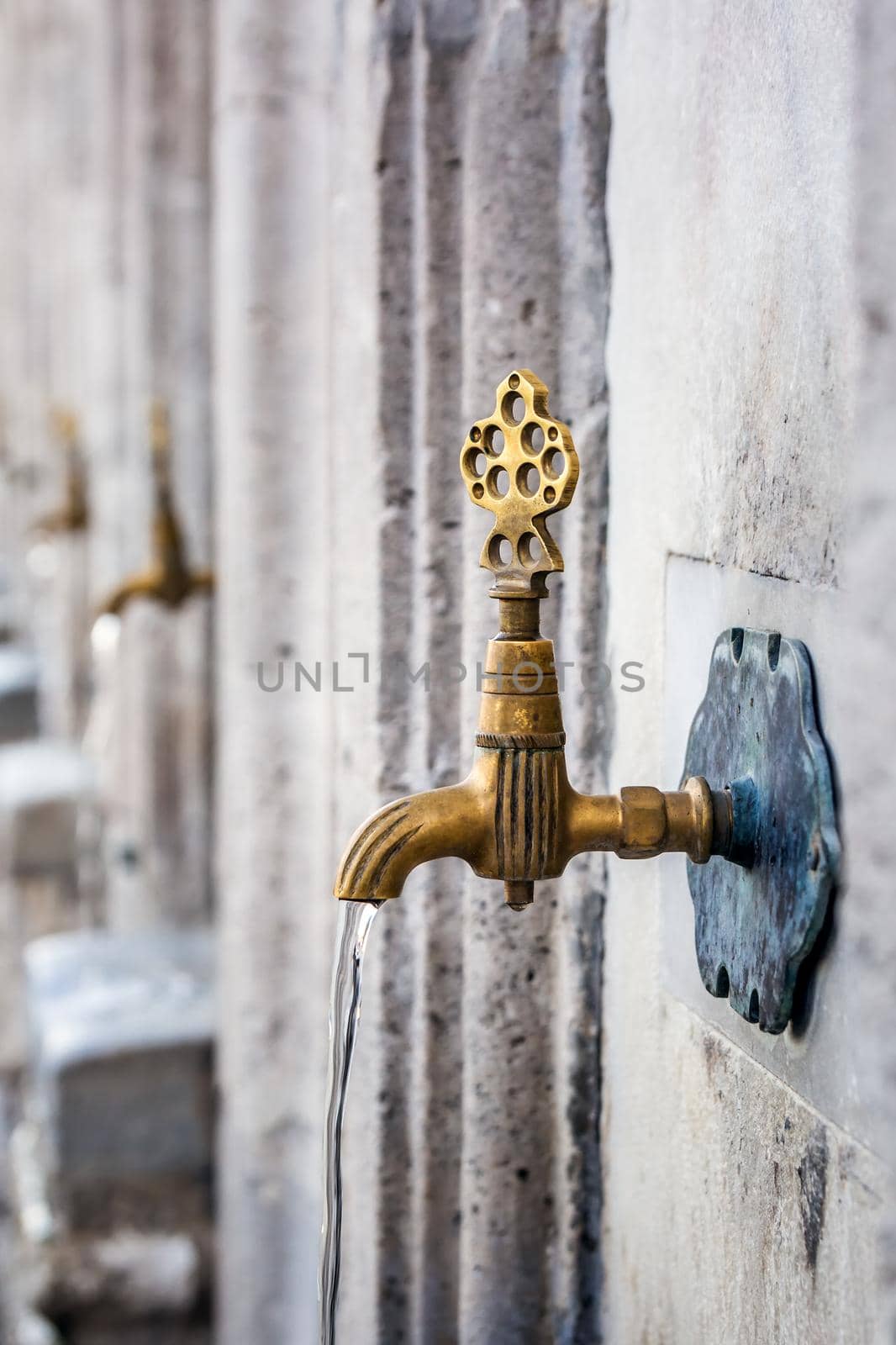 Water tap for washing hands and feet before the prayer in ablution faucets in the Suleymaniye Mosque, Istanbul, Turkey.