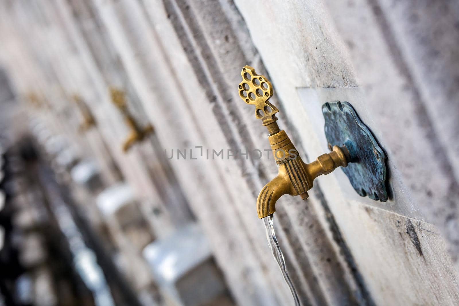 Water tap for washing hands and feet before the prayer in ablution faucets in the Suleymaniye Mosque, Istanbul, Turkey.