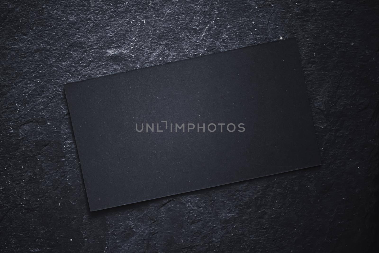 Black business card on dark stone flatlay background and sunlight shadows, luxury branding flat lay and brand identity design for mockups