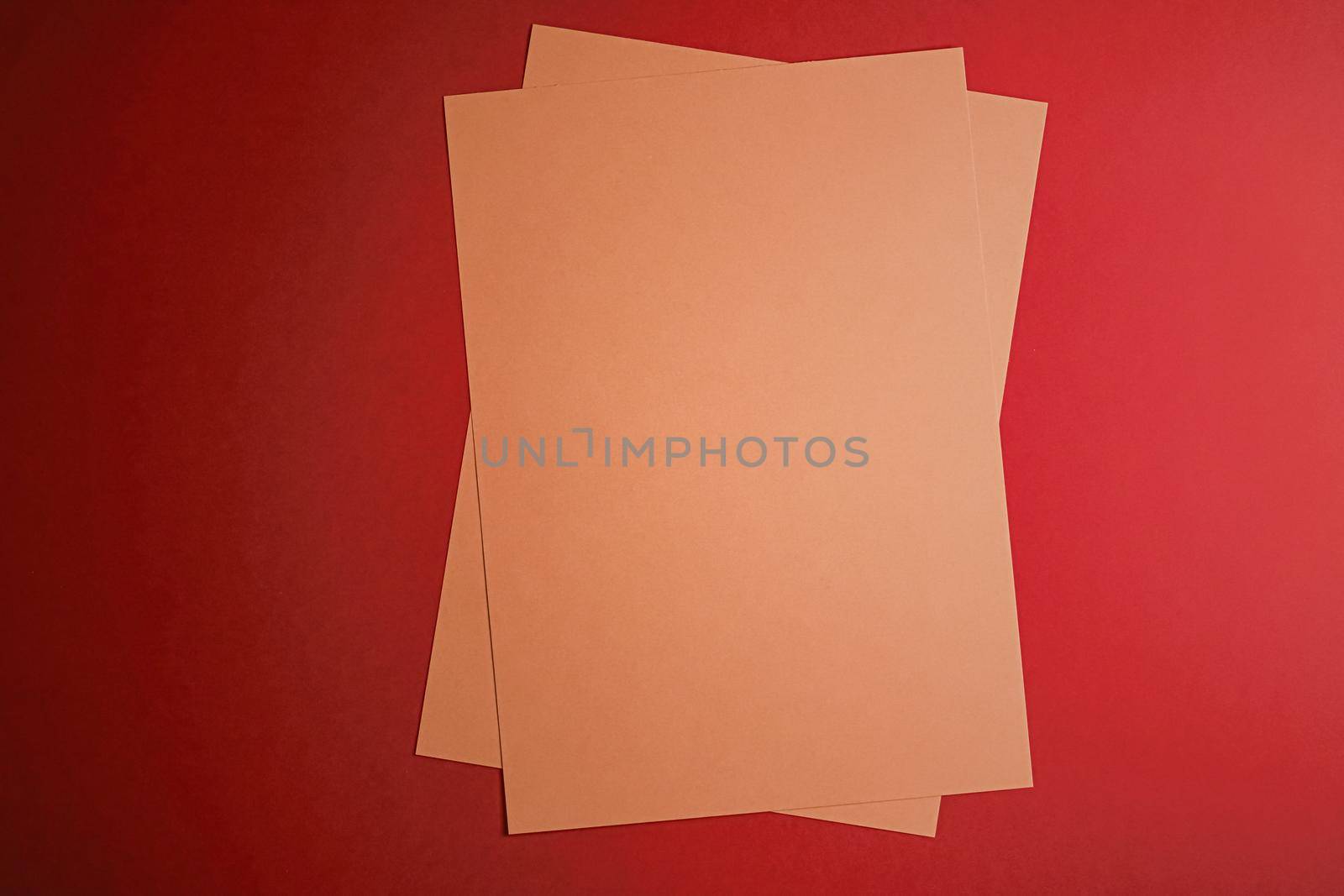 Beige A4 papers on red background as office stationery flatlay, luxury branding flat lay and brand identity design for mockups