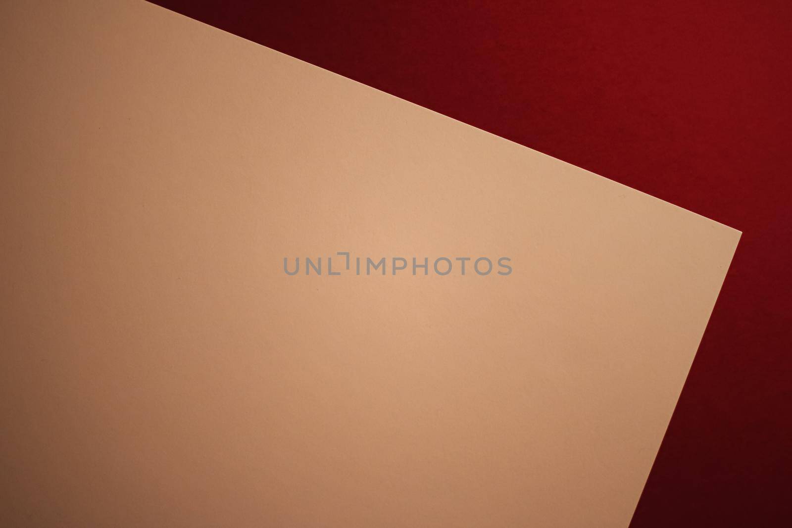 Beige A4 paper on dark red background as office stationery flatlay, luxury branding flat lay and brand identity design for mockup by Anneleven