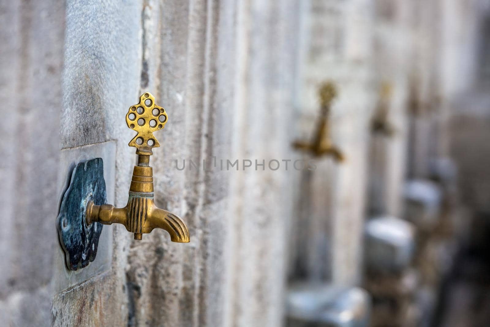 Water tap for washing hands and feet before the prayer in ablution faucets in the Suleymaniye Mosque, Istanbul, Turkey.