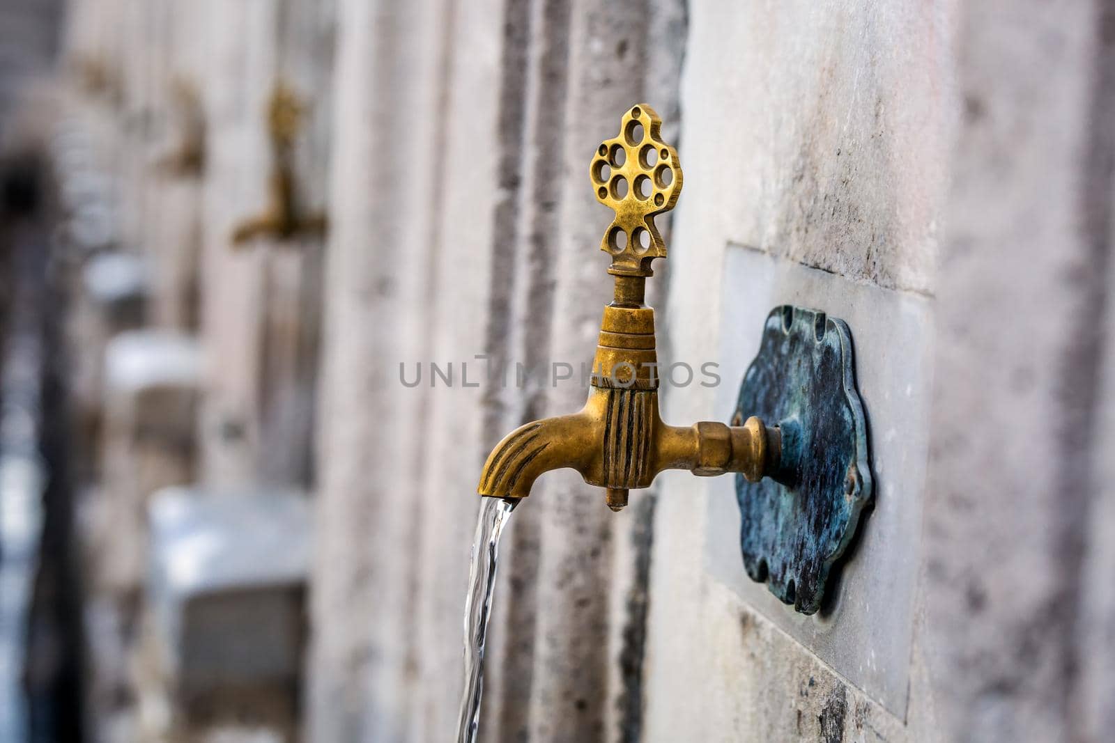 Water tap for washing hands and feet before the prayer in ablution faucets in the Suleymaniye Mosque, Istanbul, Turkey.