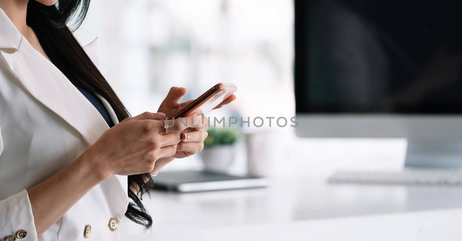 Side view of businesswoman using smartphone at her office