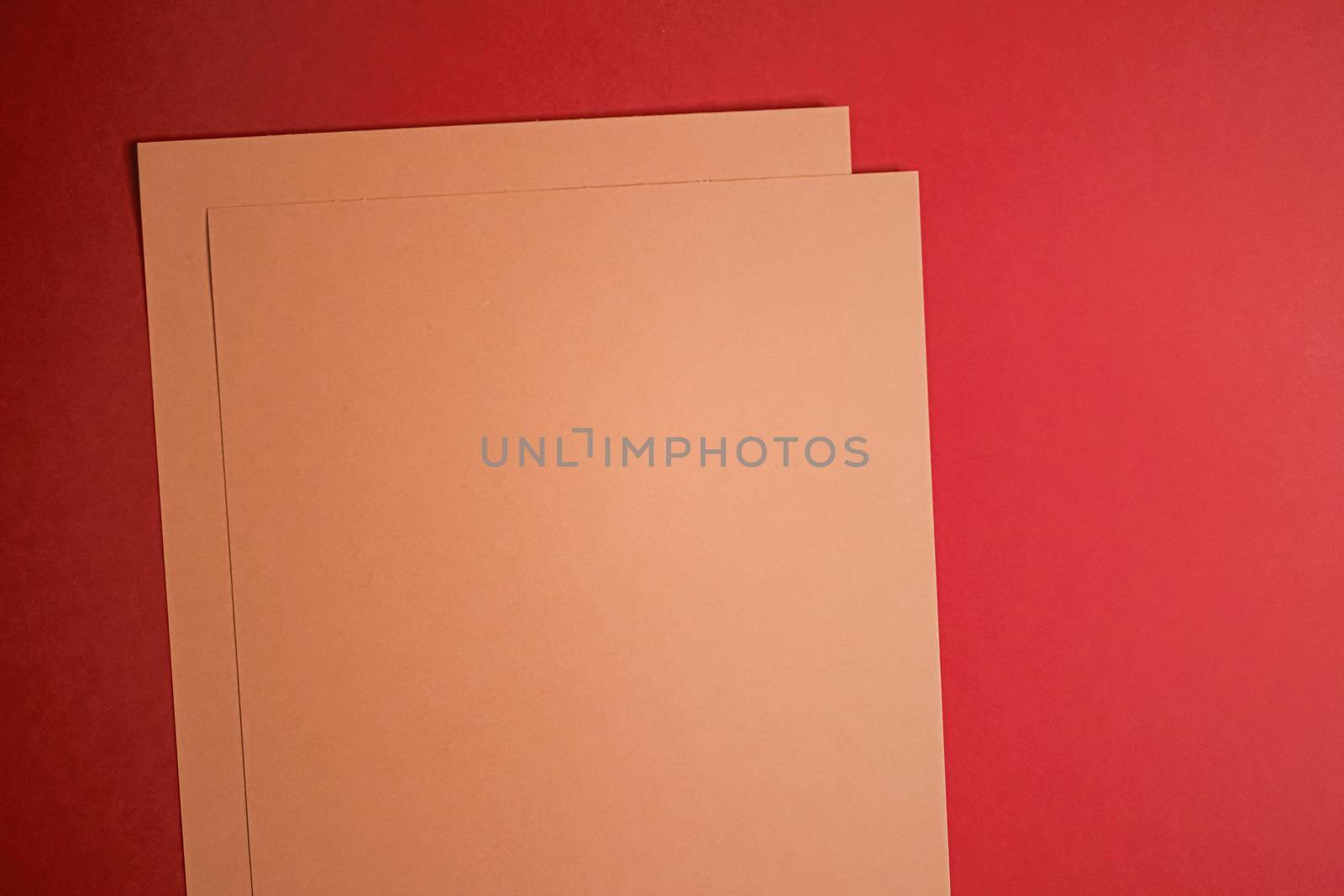 Beige A4 papers on red background as office stationery flatlay, luxury branding flat lay and brand identity design for mockups