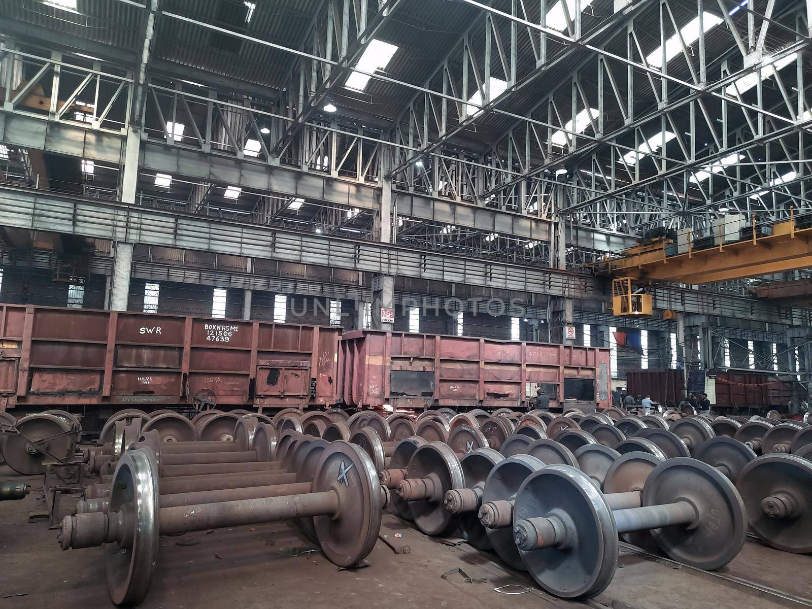 Spare railway wheels on the axle in a repair workshop by tabishere