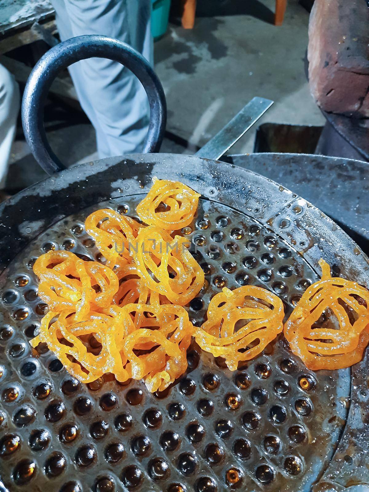 Jalebi is a famous indian sweet. This shows how jalebi are 1st fried in oil by tabishere