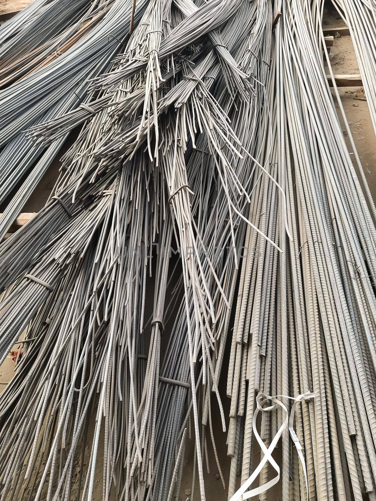 close up steel bar or steel reinforcement bar in the construction site with sunbeam at the morning, steel rods bars can use for reinforce concrete. by tabishere