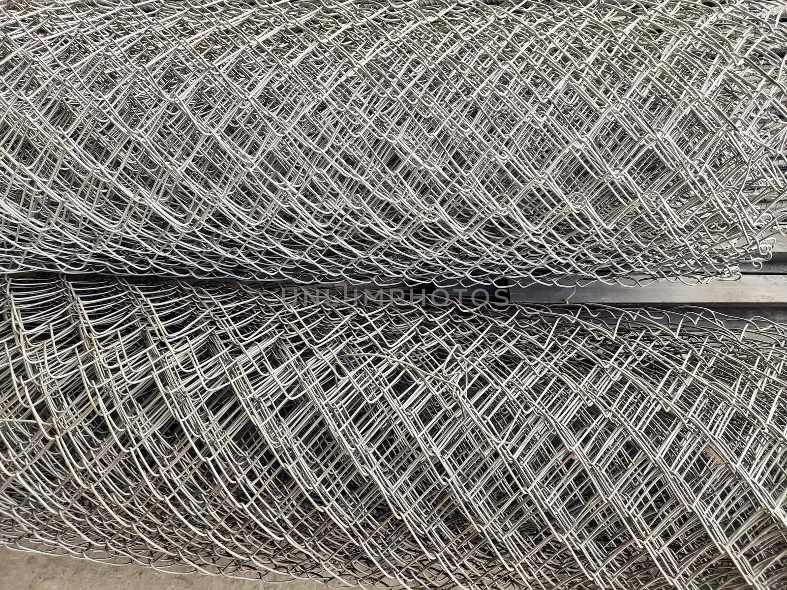 Metal bars background in diagonal lines close-up, industrial mesh of steel wire texture, building material by tabishere