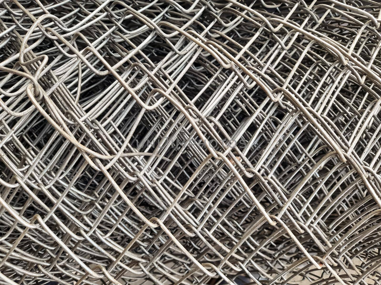close up rolls of iron mesh (wire mesh) in construction site. metal steel reinforced rod for concrete. building construction and industry concept - image by tabishere