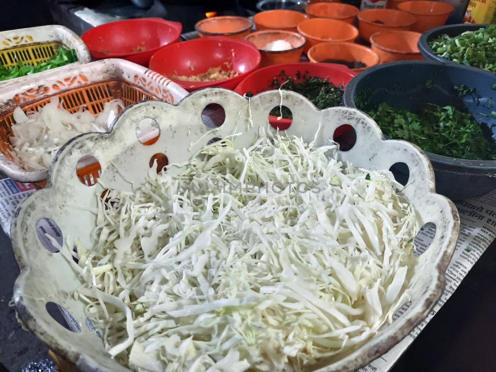 Top view closeup of tomato sauce, lettuce, rice, onions and other appetizers cut in silver bowls by tabishere