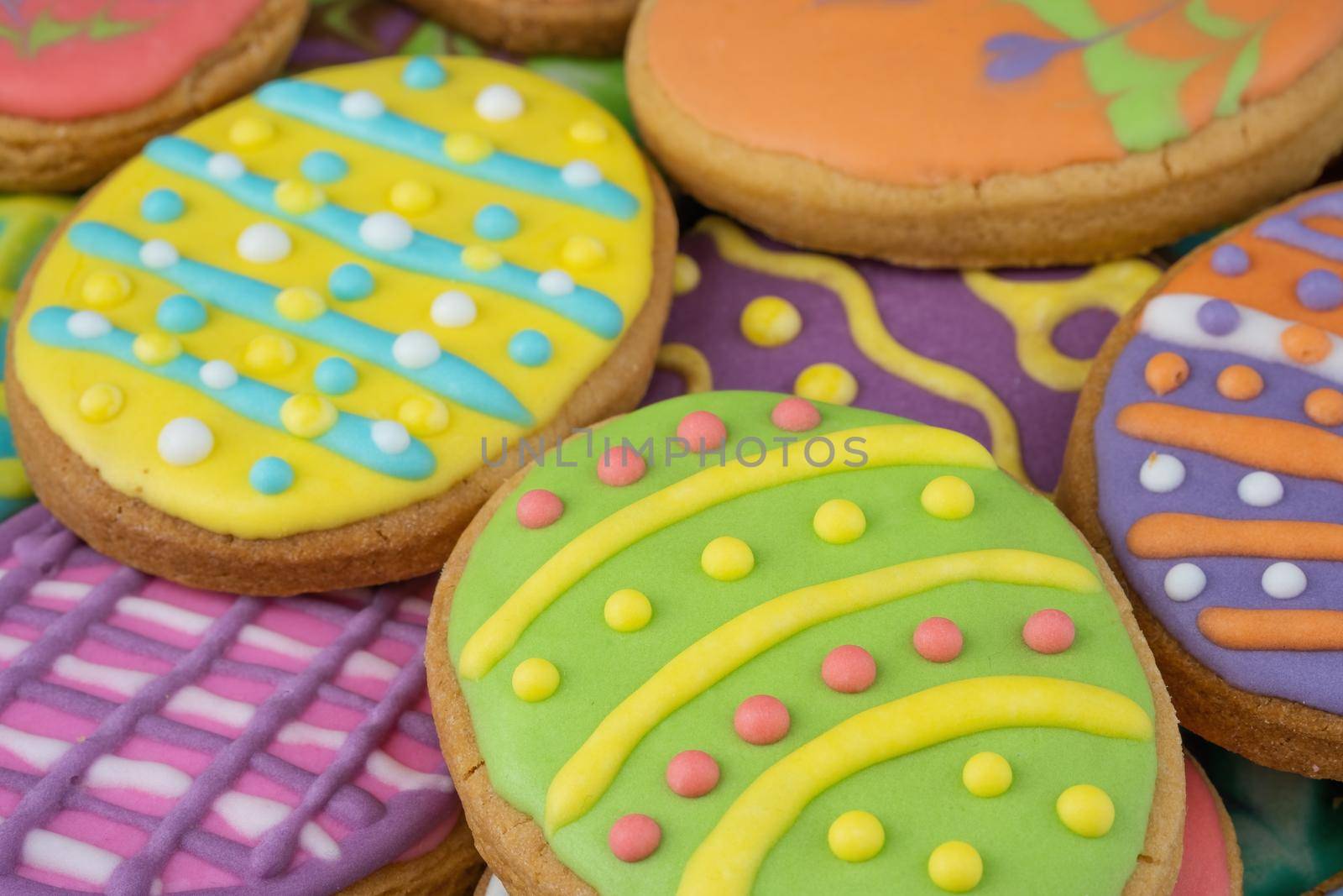 Easter decorated baked eggs, cookies as background.