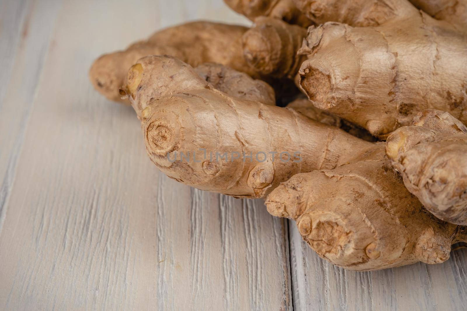 Fresh, light, healthy ginger on white wooden background by Fischeron